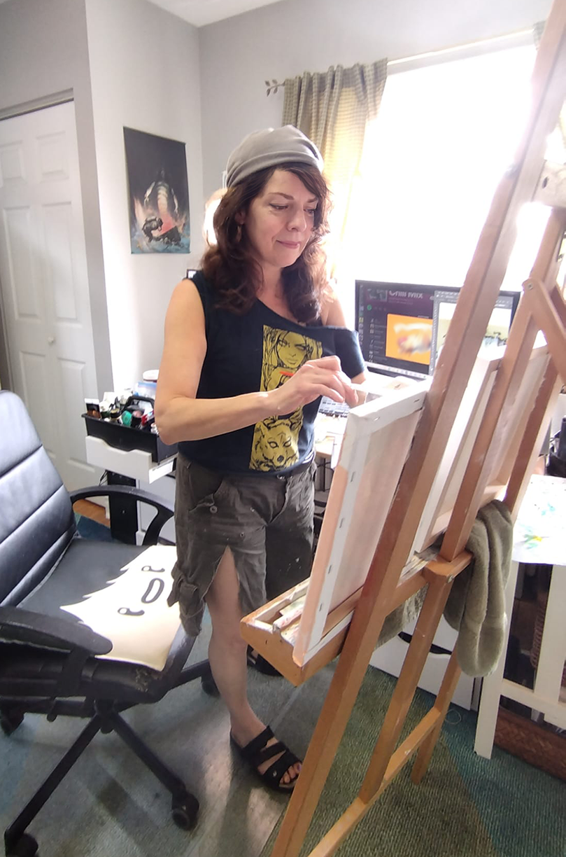 environmental activist artist, Pamela Paulenko from Ontario, Canada, behind her easel in Toronto painting Canadian wildlife art with a conservation mission 