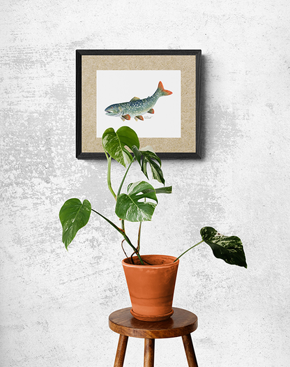 This is a picture of  a Fish painting hung near a single plant